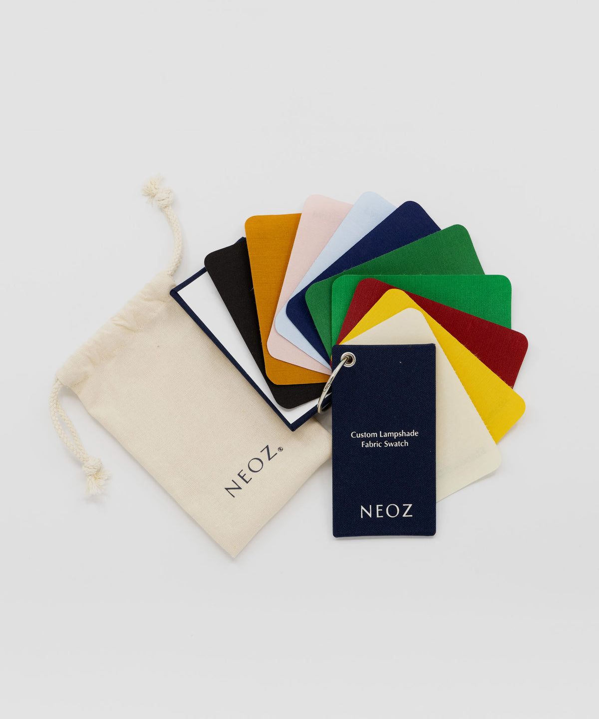 NEOZ custom lampshade silk fabric swatch pack with branded pouch, fanned out to show colour range