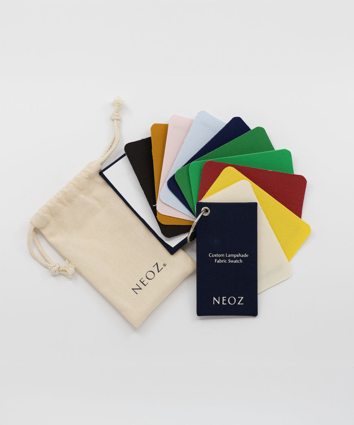 NEOZ custom lampshade cotton fabric swatch pack with branded pouch, fanned out to show colour range