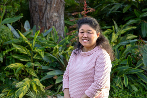Photo of Lily Pan from NEOZ Lighting in front of a green garden.