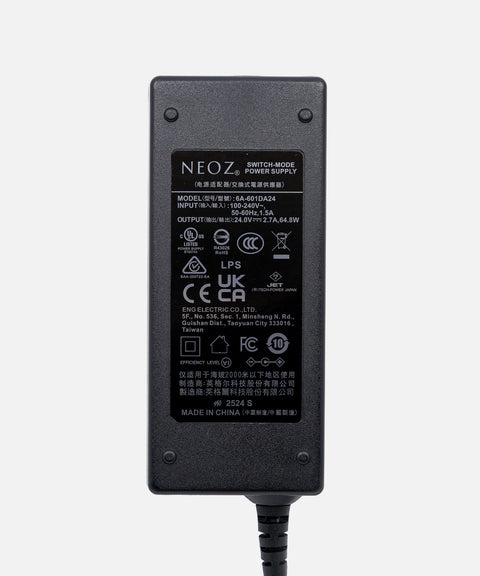 NEOZ 65W power supply for N1 Charging Tray – compact switch-mode adapter with 24V 2.7A output for six cordless lamps.